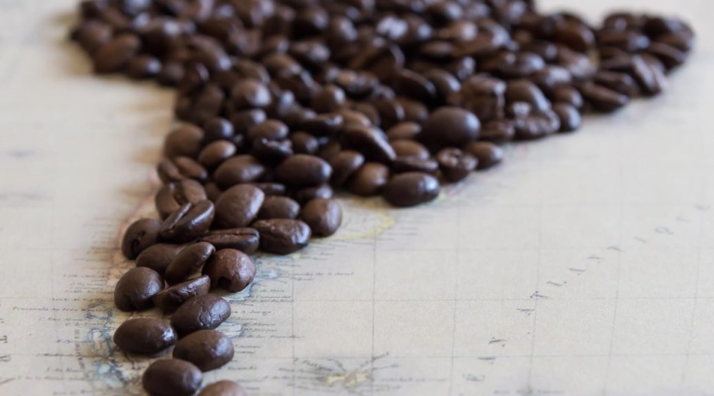 Map of South America covered in coffee beans, representing the region's coffee production.